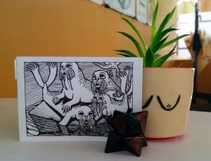 Image of a postcard of Joren Eulalee’s Walrus Dispute sitting on a desk
